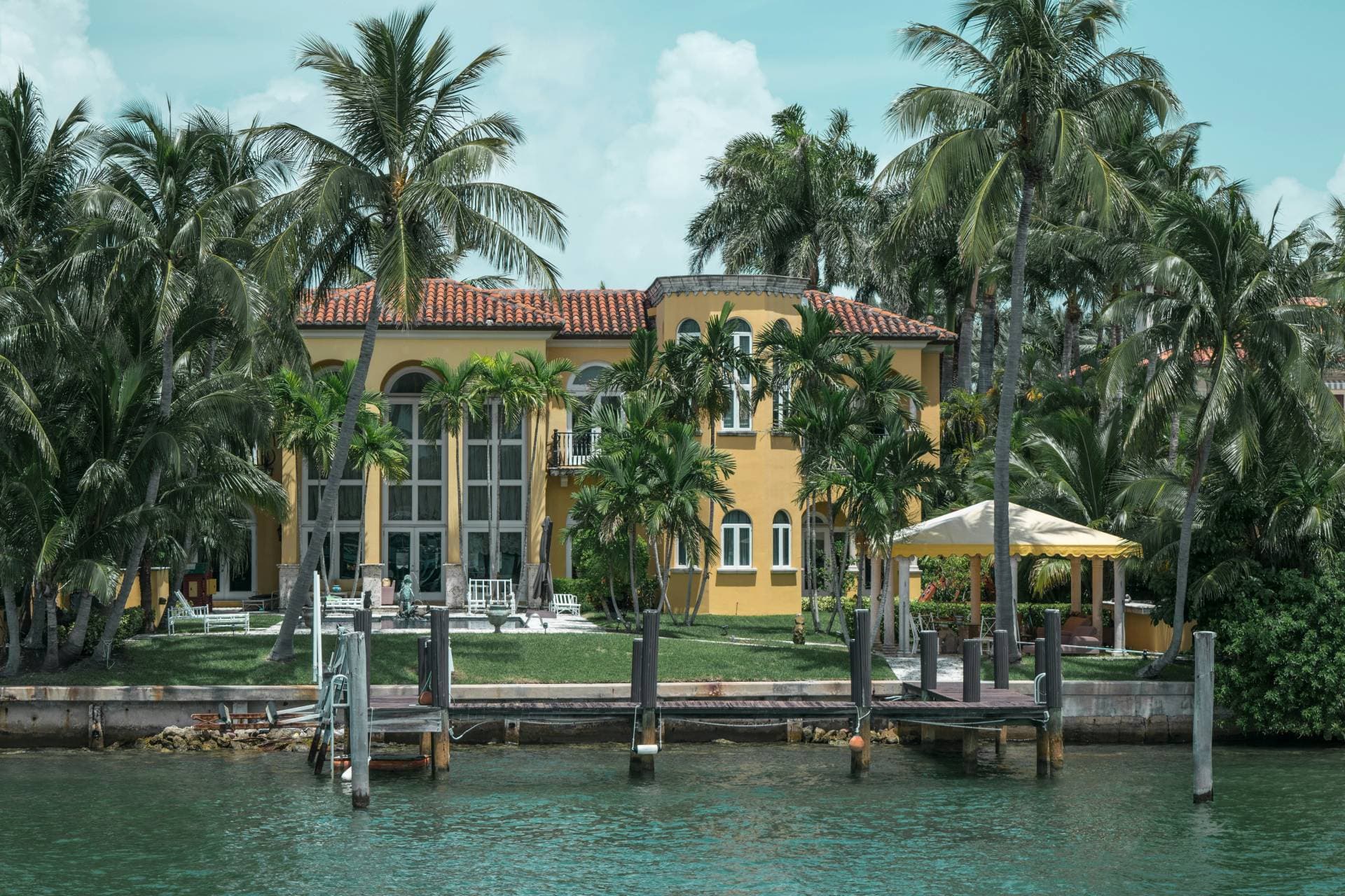Miami waterfront residence with palm trees — First American Arborists South Florida